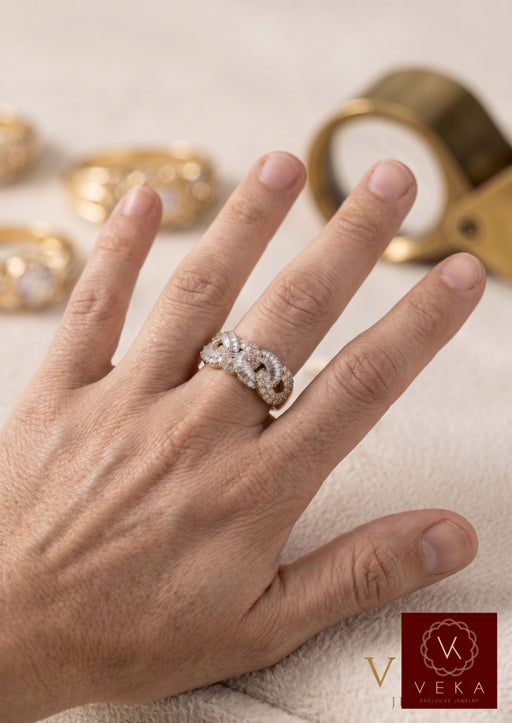 Side view of hand wearing 10K gold Cuban link ring with round and baguette diamonds