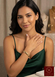 Beautiful Latina model wearing an 8.5mm semi-solid 14k gold Italian Cuban link bracelet on her wrist, styled for a luxury jewelry catalog look.