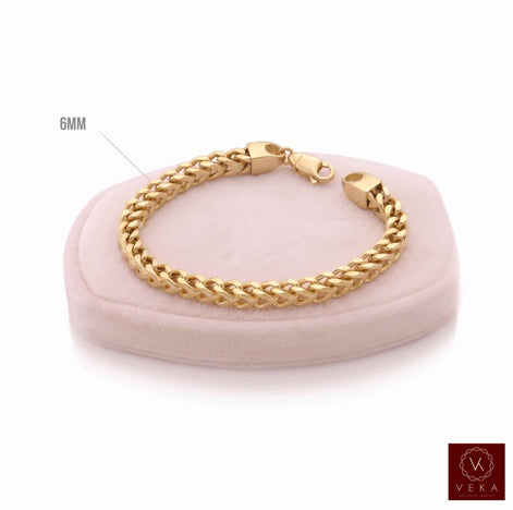 Men's 10K yellow gold 6mm semi-solid Franco chain bracelet on a luxury display cushion by Veka Jewelry