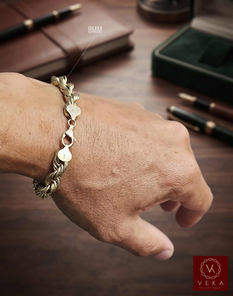 Man wearing an 8mm hollow 10K yellow gold rope bracelet on his wrist from the Veka Jewelry collection