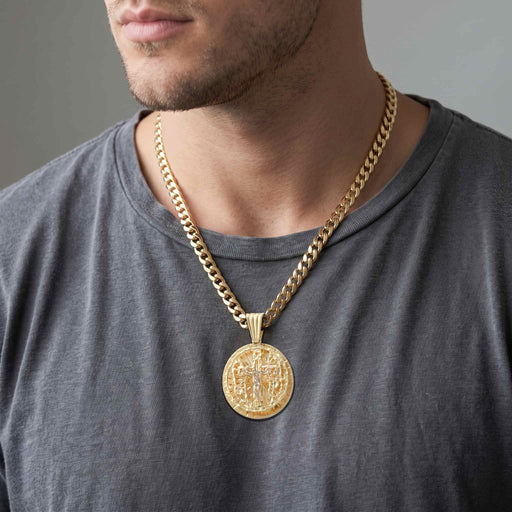 Male model wearing 10K yellow gold crucifix globe medallion pendant on Cuban link chain by Veka Jewelry