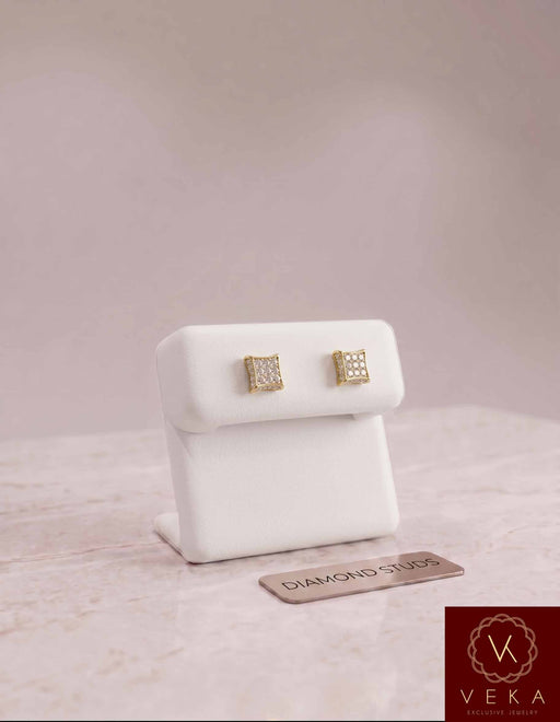 Men's 10K gold diamond square stud earrings, 1/6 CTW, showcased on a white display stand by Veka Jewelry.