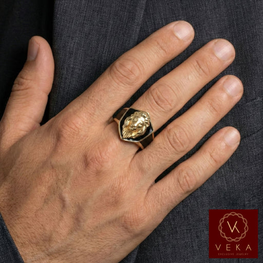 Male model wearing a 10k yellow gold lion head ring with black enamel accents on the ring finger.
