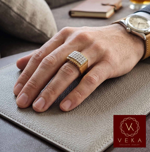 Lifestyle shot of a man wearing a large 10k yellow gold pave diamond statement ring by VEKA Jewelry