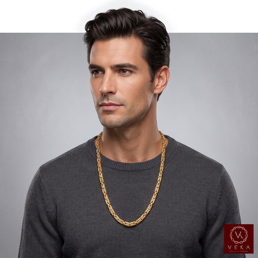 Male model wearing a 10K yellow gold 3mm byzantine chain necklace styled with a casual grey sweater from Veka Jewelry.