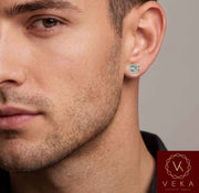 Close-up lifestyle portrait of a male model wearing a 10k yellow gold round brilliant lab-grown diamond halo stud earring from Veka Jewelry.