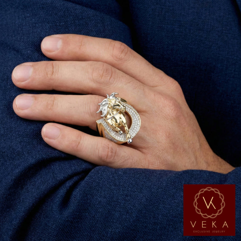 A male model's hand wearing the 14K two-tone gold horse and CZ horseshoe ring on the ring finger, resting against a dark blue suit sleeve.