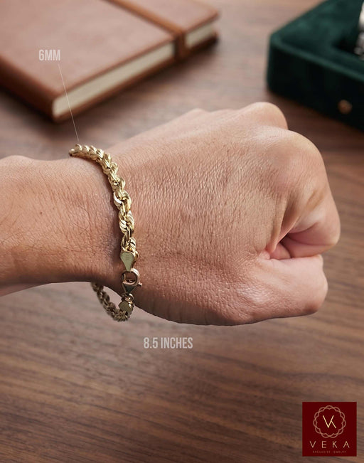 Man wearing a solid 14k gold 6mm rope bracelet measuring 8.5 inches long from Veka Jewelry