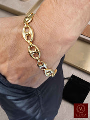 Lifestyle view of a man wearing the 15mm 10K yellow gold puffed mariner link bracelet by Veka Jewelry