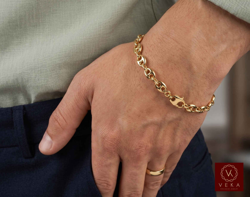 Lifestyle view of a man wearing the 7mm 14K yellow gold puffed mariner link bracelet by Veka Jewelry