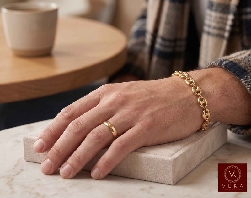 Lifestyle view of a man wearing the 9mm 14K yellow gold puffed mariner link bracelet by Veka Jewelry