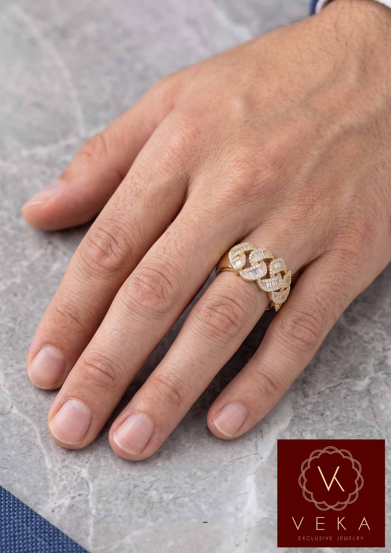 Close-up of a man's hand wearing a wide gold Cuban chain style ring set with diamonds, luxury lifestyle jewelry photography.