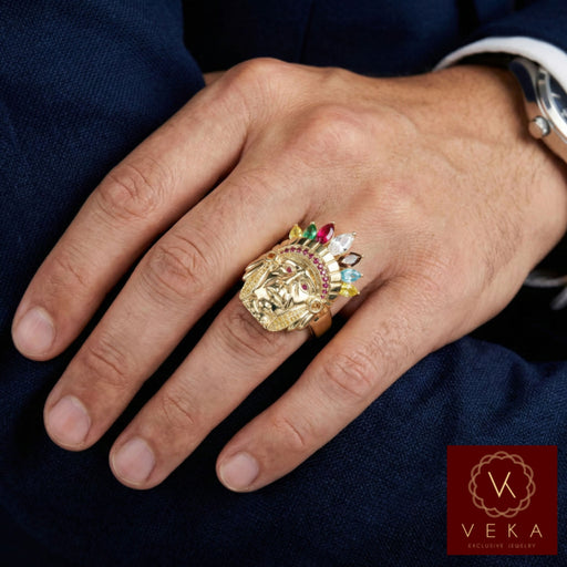 Male model hand wearing a heavy 10k gold Indian Chief ring with colorful synthetic stones on the ring finger against a dark suit.