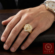 Male model wearing a 14K gold lion head ring with cubic zirconia stones on the ring finger. Luxurious men's jewelry by VEKA Jewelry