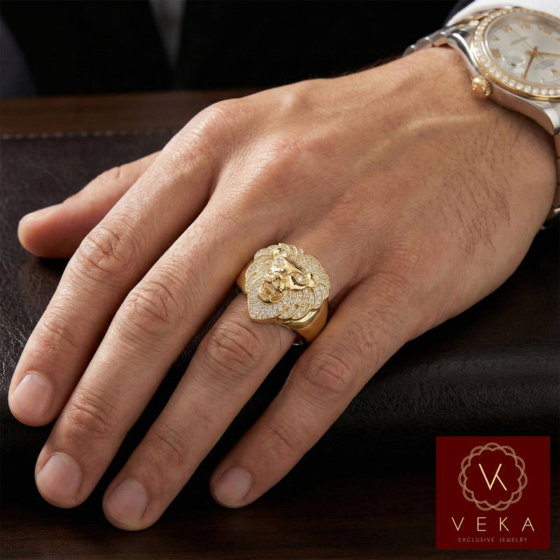 Male model wearing a 14K gold lion head ring with cubic zirconia stones on the ring finger. Luxurious men's jewelry by VEKA Jewelry