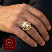 Male model wearing a 10K gold lion head ring with pave cubic zirconia and green emerald eyes on the ring finger