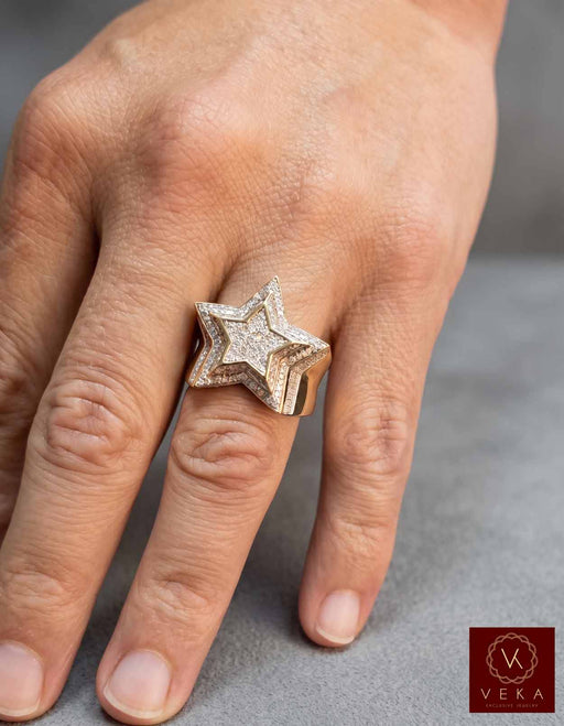 On-hand view of the men's 10K gold and 7/8 CTW diamond star ring by VEKA Jewelry, showing its substantial scale and luxurious brilliance.
