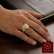 Male model wearing a 14K gold tiger head ring with red ruby eyes on the ring finger. Bold men's statement jewelry by VEKA Jewelry.