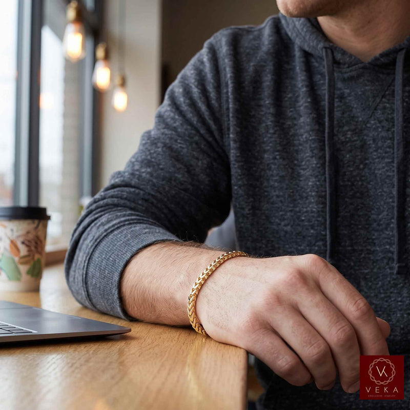 Lifestyle shot showing a man wearing the solid 10k diamond cut gold franco 4mm bracelet by Veka Jewelry in a cafe