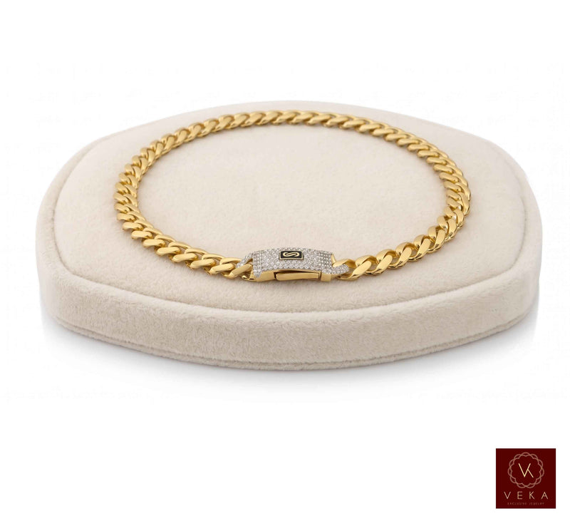 Monaco Chain™ Classic Pavé Lock Cuban link bracelet in 14K real yellow gold, 7mm width, displayed on a professional white jewelry pillow by Veka Jewelry