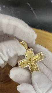 10K yellow gold Jesus crucifix pendant video on a hand with white glove showing how it looks in a chain.