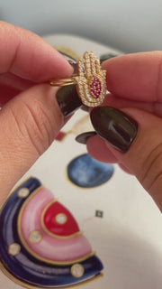 Luxurious 14 Karat Gold Hamsa Ring with vibrant synthetic ruby center and sparkling zirconium clear stones. Affordable real Jewelry - VEKA JEWELRY