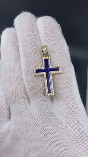 Gloved hand holding the 14K yellow gold blue enamel cross pendant to demonstrate real-life scale, sparkle, and high-polish finish.