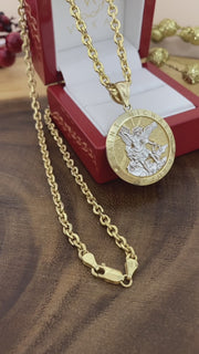 Real gold two-tone Saint Michael medal paired with gold chain necklace presented in luxury Veka Jewelry gift box.