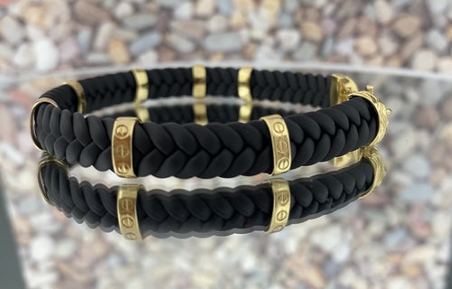 14k-solid-gold-braided-black-leather-mens-bracelet-vidfeo-rotating on a mirrior