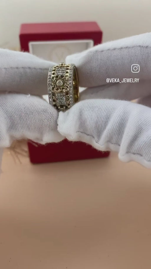 A close-up video showing the functioning mechanical gear mechanism and spinning action of the solid 10K yellow gold and diamond band from VEKA Jewelry.