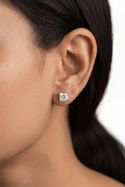 Side view of a 6mm princess cut lab grown diamond earring on a female model’s earlobe, showcasing 14k white gold setting and brilliance.