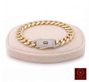Men's real 14K yellow gold Monaco chain bracelet, 11mm width, featuring a diamond-accented clasp on a beige display stand by Veka Jewelry.