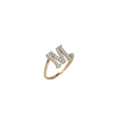A yellow gold ring with a single initial 'M' adorned with zirconia stones.