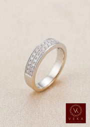 Side profile view of a luxury men's diamond wedding ring in 14K white gold with 30 natural diamonds set in a double-row channel on a textured beige background.