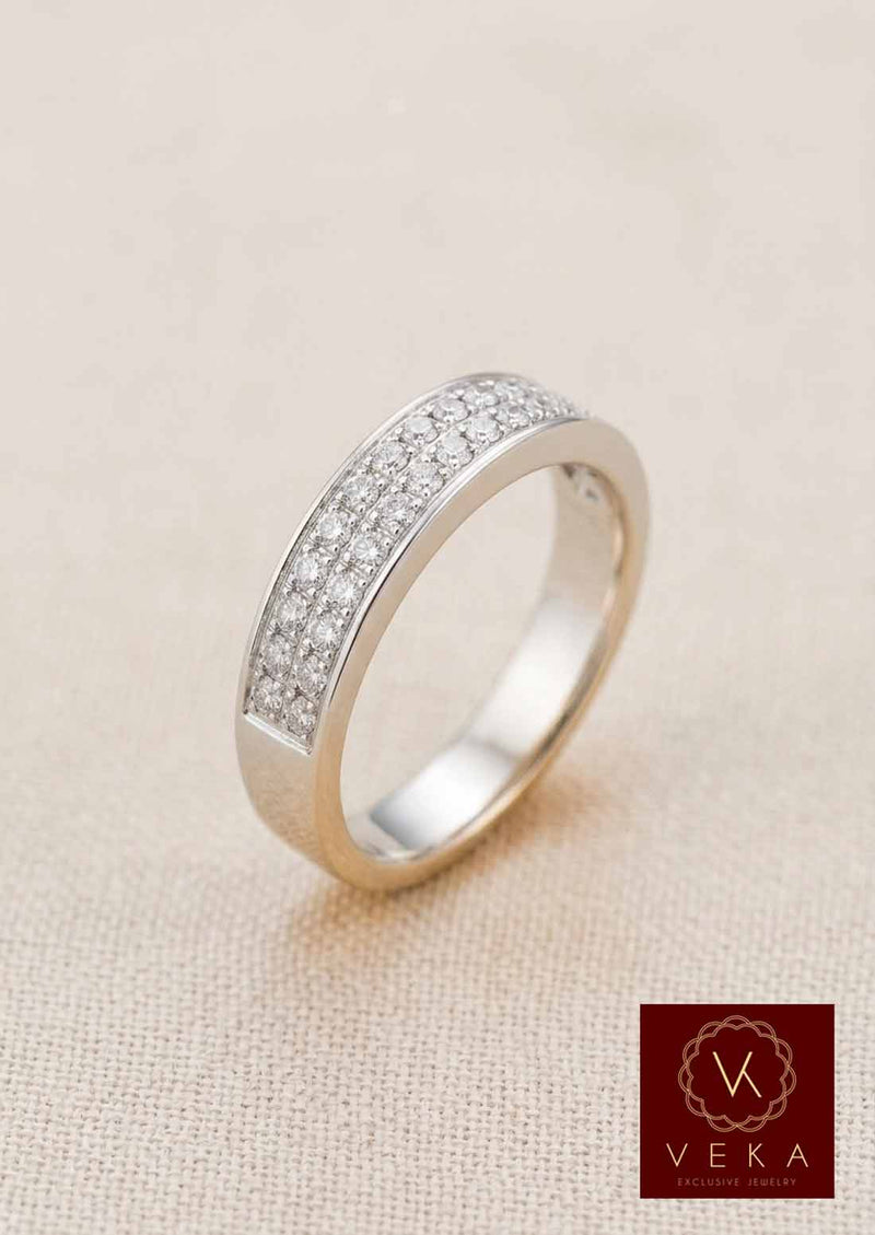 Side profile view of a luxury men's diamond wedding ring in 14K white gold with 30 natural diamonds set in a double-row channel on a textured beige background.