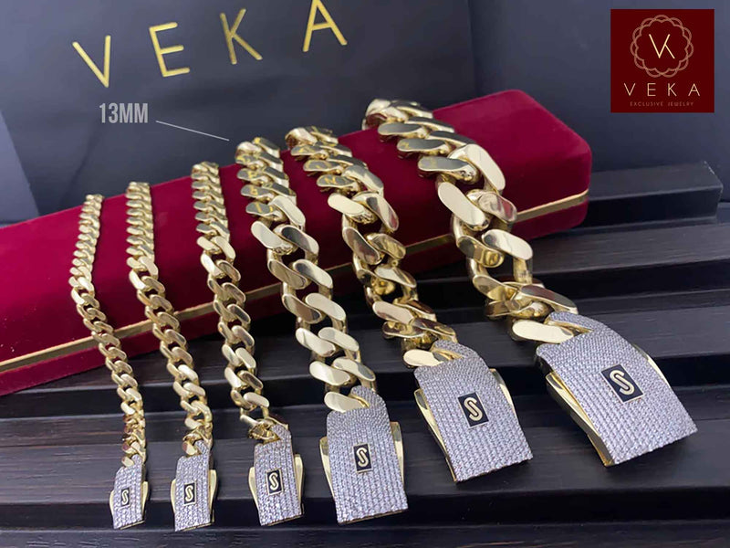 A collection of genuine 14k gold Monaco chain bracelets with Pavé Lock in various sizes displayed on a luxury red velvet box by Veka Jewelry