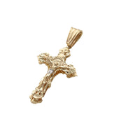 Angled side perspective of solid 14k yellow gold textured nugget crucifix pendant showing bail and relief detail