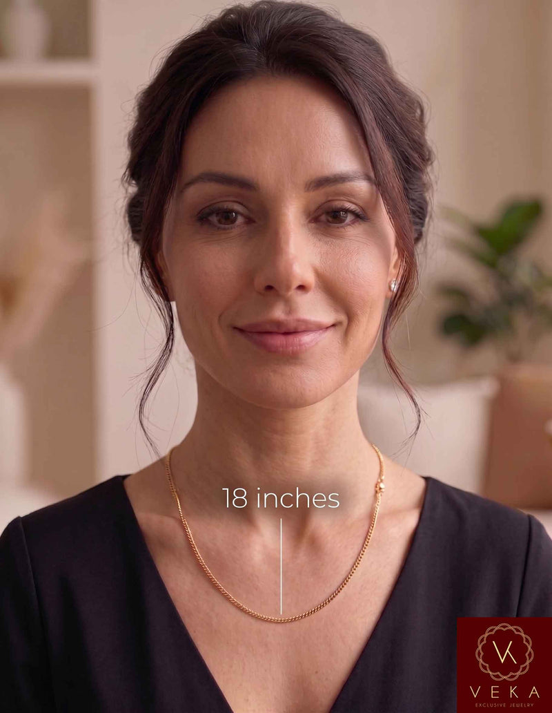 An elegant adult woman wearing a solid 2mm Miami Cuban link 14k solidgold chain. The image features a measurement guide highlighting the 18-inch length resting beautifully on the neckline, by Veka Jewelry