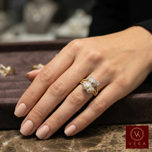 Female model wearing a luxury 10k gold teddy bear diamond ring on her ring finger, showcasing the scale and brilliance.