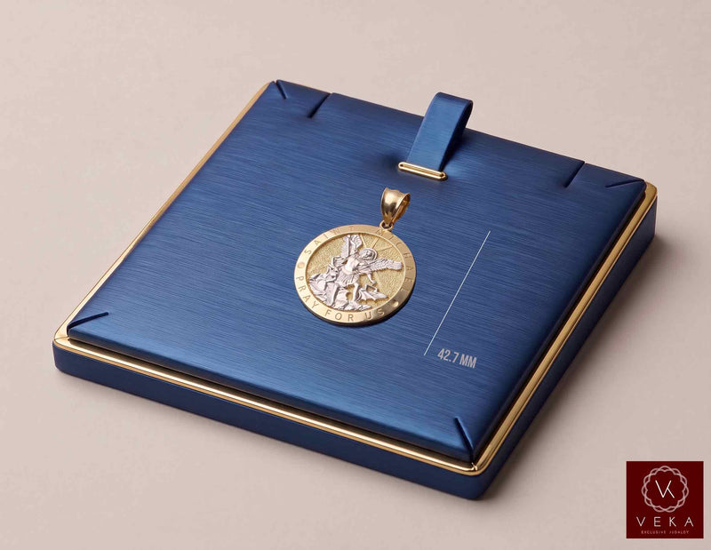 Two-tone real 10K and 14K gold St. Michael Pray For Us medal pendant displayed on luxury navy blue jewelry pad by Veka Jewelry.