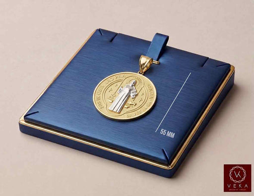 Two-tone solid gold Saint Benedict medal pendant 55mm displayed on a luxury navy blue jewelry pad by Veka Jewelry