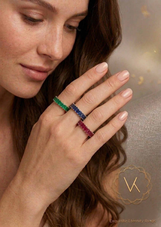 VEKA Jewelry 14K gold eternity bands featuring natural emerald-cut ruby, sapphire, and emerald on a model's hand