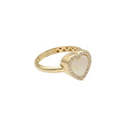 Macro detail of a 14K yellow gold heart ring by VEKA Jewelry, highlighting the glowing mother of pearl inlay and brilliant-cut cubic zirconia accents.