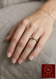 Woman wearing VEKA 14K yellow gold 0.25 Ctw diamond cluster engagement ring on hand.