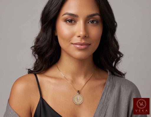 A beautiful model of Latina descent wears the 14K Gold Virgen de Guadalupe CZ Medallion Pendant on a delicate gold chain, illustrating how the religious fine jewelry piece rests and is styled in a lifestyle context.