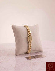 VEKA Jewelry 7mm Miami Cuban link bracelet in authentic 10K solid yellow gold displayed vertically on a beige velvet jewelry pillow