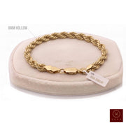 8mm hollow rope chain bracelet in 10K yellow gold (8 inches, 8 grams) displayed on a beige stand by Veka Jewelry.
