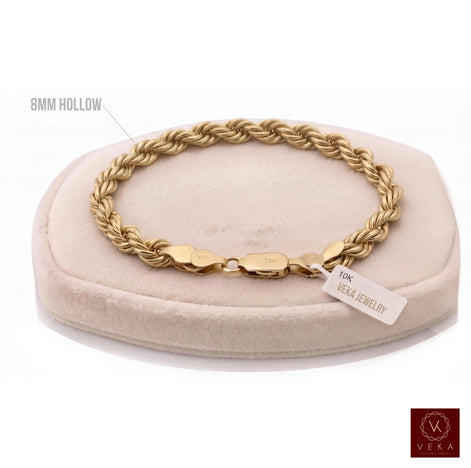 8mm hollow rope chain bracelet in 10K yellow gold (8 inches, 8 grams) displayed on a beige stand by Veka Jewelry.