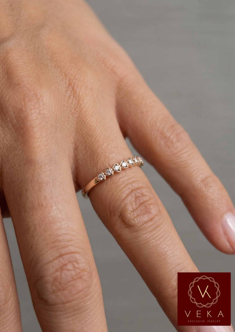 Veka Jewelry 10K yellow gold heart-shaped natural diamond stackable band worn on a model's hand.