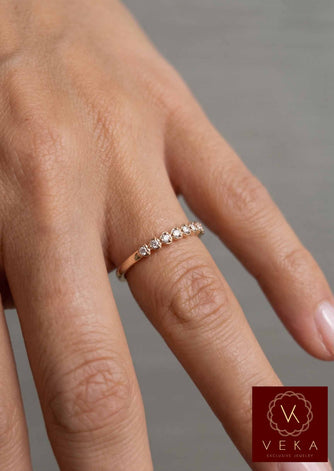 Veka Jewelry 10K yellow gold heart-shaped natural diamond stackable band worn on a model's hand.